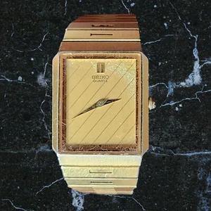 Reloj Seiko Vintage Hombre 26mm Esfera Dorada Tono Dorado Estilo Tanque Batería Nueva - Imagen 1 de 8