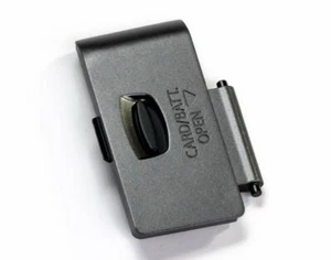 New Genuine Battery Door Cover Canon EOS 1100D Silver Snap Cap CG2-3063-000 - Picture 1 of 8