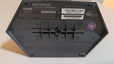 Cable módem NETGEAR CM1000, DOCSIS 3.1, negro con adaptador de corriente Foto 1 de 4