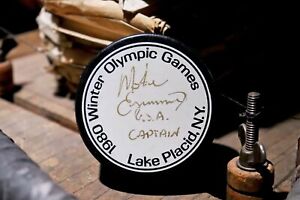 1980 winter olympics lake placid  official hockey puck signed by Mike Eruzioe