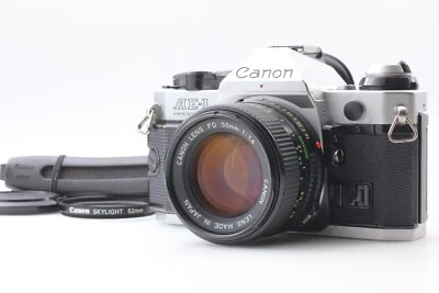 【N COMO NUEVA】 Cámara fotográfica plateada programa Canon AE-1 nueva lente FD NFD 50 mm f/1,4 JAPÓN Foto 1 de 4