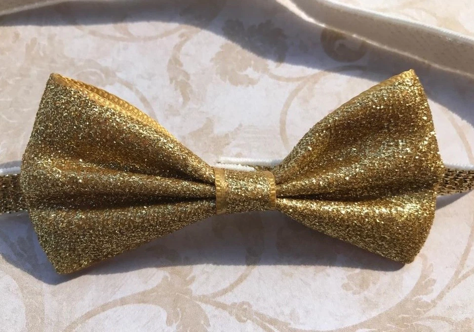 Diadema metálica plateada o dorada con lazo para bebé Foto 1 de 1