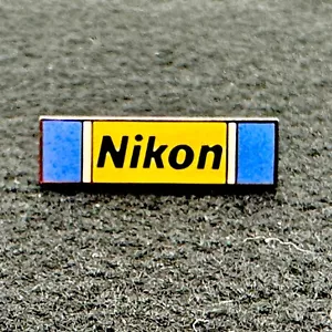 NUEVO Pin de solapa vintage Nikon amarillo y azul con letras negras - Imagen 1 de 4