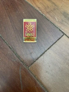 1988 Calgary Winter Olympics Lapel Pin - Coca Cola w red Snowflake Artiss Regina - Picture 1 of 2