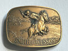 Vintage 1975 Smith & Wesson "The Hostiles" Cowboy Riding Horse Brass Belt Buckle