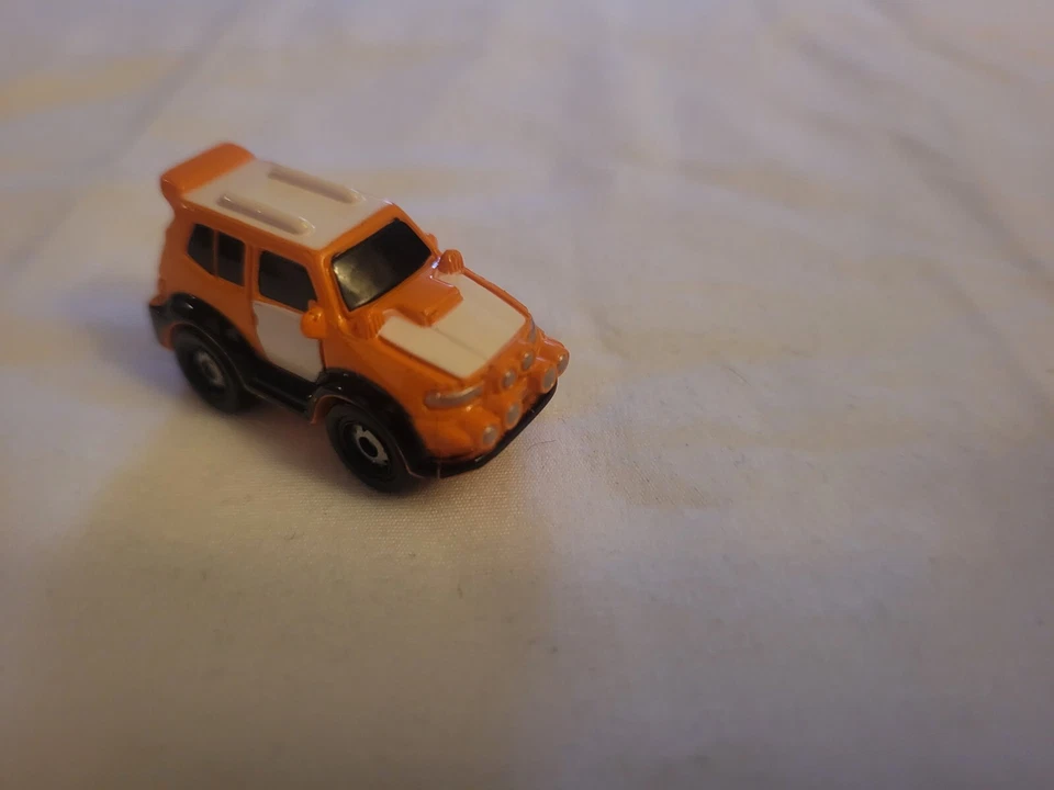 Small Hasbro Micro Machine SUV in Orange and White - Image 1 of 4