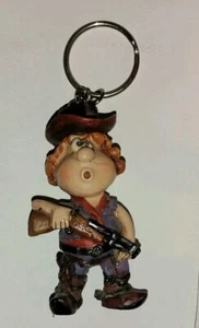 Crazy Crosseyed Cowboy Schlüsselanhänger Figur möglich Vintage tragende Flinte Narbe - Bild 1 von 6