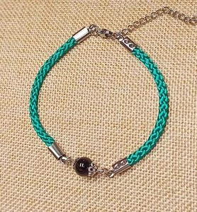 BRACCIALE ARTIGIANALE IN CORDINO NAUTICO VERDE CON "SU COCCU" IN ONICE INOX - Imagen 1 de 7