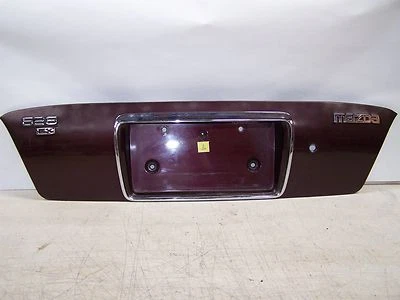 Mazda 626 1998 maletero trasero plataforma montaje en etiqueta maletero centro borgoña Foto 1 de 4