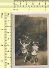 Two Girls Playing Outside with Plants Mask Costume Flowers Abstract old photo