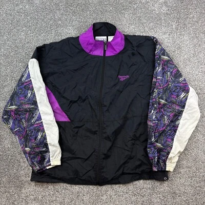 Chaqueta cortavientos Reebok para hombre grande negra púrpura mangas abstractas retro cremallera Foto 1 de 4