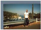COLOR PHOTO F_1984 MAN STANDING ON CATALINA ISLAND ROAD,CASINO BEHIND