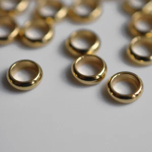10 uds. / ID: 5 mm 7 x 2 mm acero inoxidable cuentas anillos cuentas correderas colores oro - Imagen 1 de 2
