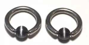 Sexy Conjunto 10g 1/2 Ojos de Gato Negro Anillo Cautivo Pezón Labio Nariz Acero Quirúrgico 316L - Imagen 1 de 2