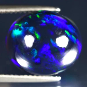7.41 ct Terrific Oval Cabochon (14 x 12 mm) Ethiopian Flashing Black Opal - Picture 1 of 2