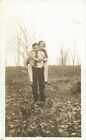 antique photo man gives woman piggy back ride man carries woman on back forest