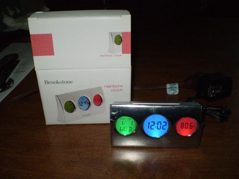 BROOKSTONE RAINBOW CLOCK TIME DATE AND TEMPERATURE IN THREE BRIGHT COLORS "NEW" Cover
