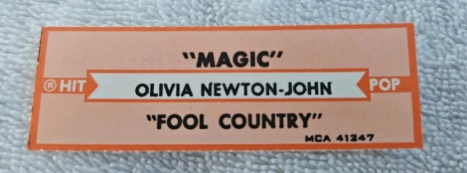 VINTAGE JUKEBOX Title Strip OLIVIA NEWTON-JOHN "Magic" & "Fool Country" 1980 - Image 1 of 1