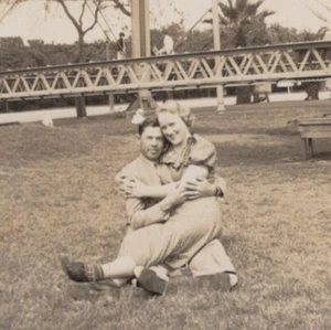 1940s Couple Grass Woman Holding Child Playful Atmosphere Bridge - Picture 1 of 3