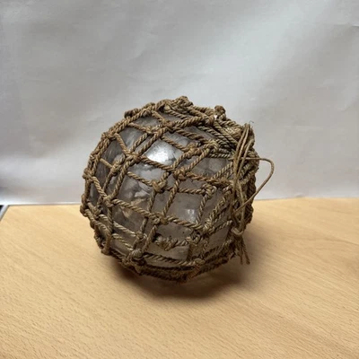 Vintage hand blown Clear Glass Fishing Float Buoy in Rope Net- 5” Nautical Decor - Image 1 of 4