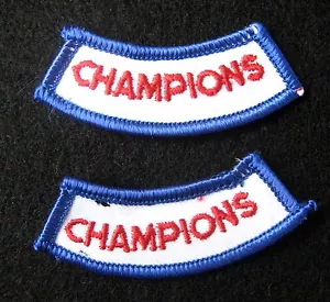 LOTTO 2 TOPPE DA CUCIRE RICAMATE CHAMPIONS UNIFORME NOME 2 1/2" X 1" NOS - Foto 1 di 1