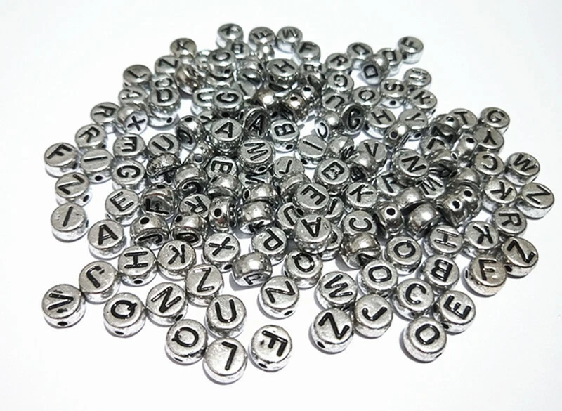 100pz misti Alfabeto / lettere di perline 7x3,5mm colore argento - Immagine 1 di 1