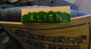 Vintage Tie Tack Cap Lapel Pin - ALIEN Green Mountain White on Metal Base - Picture 1 of 3