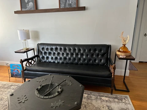 Vintage Spanish Revival Black Tufted Faux Leather Couch with Ornate Wooden Arms Cover