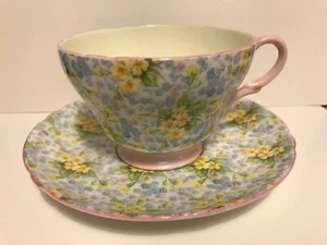 PRETTY SHELLEY PRIMROSE CHINTZ PINK ENGLISH PORCELAIN CUP SAUCER YELLOW FLOWERS - Picture 1 of 9