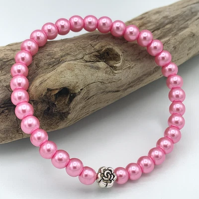 Pulsera elástica elástica elástica de perlas de vidrio rosa de 6 mm y dije de flores de plata tibetana Foto 1 de 2