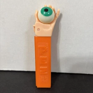 Vintage Pez Dispenser No Feet Psychedelic Hand Holding Eye Orange Stem - Picture 1 of 8