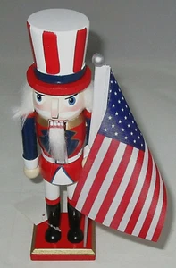 PATRIOTIC NUTCRACKER ~ 10 inches ~ UNCLE SAM HOLDING AMERICAN FLAG - Imagen 1 de 4