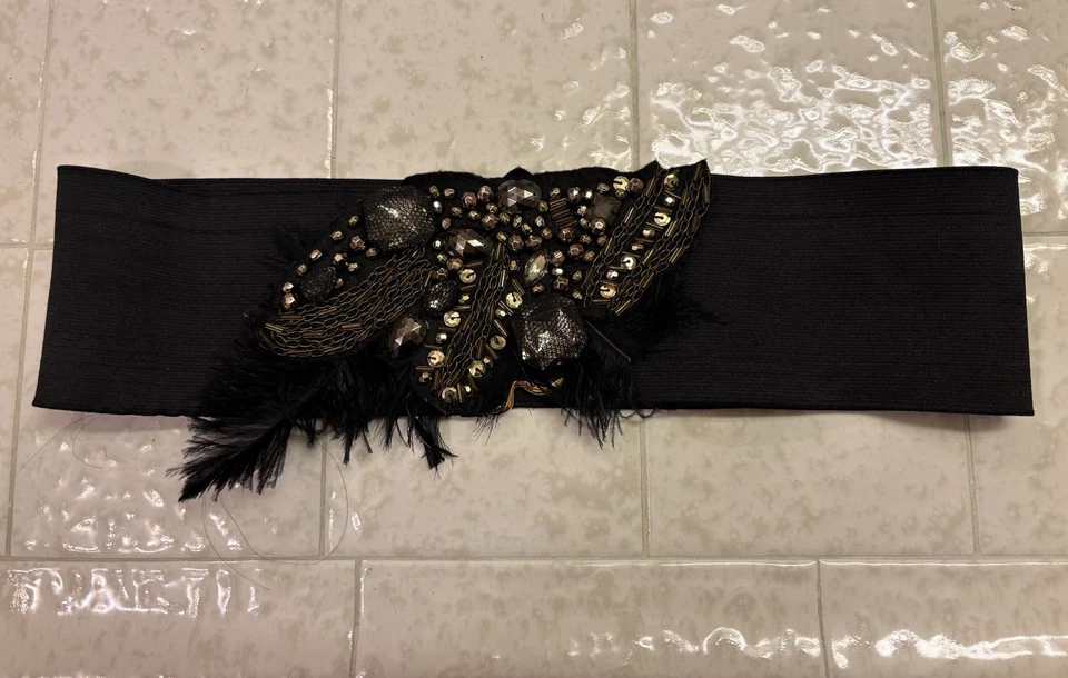 Cinturón Bebe ancho llamativo con pluma negro elástico talla S Foto 1 de 4