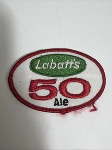 Parche vintage Labatt’s 50 Ale rojo blanco verde 3x2 - Imagen 1 de 8