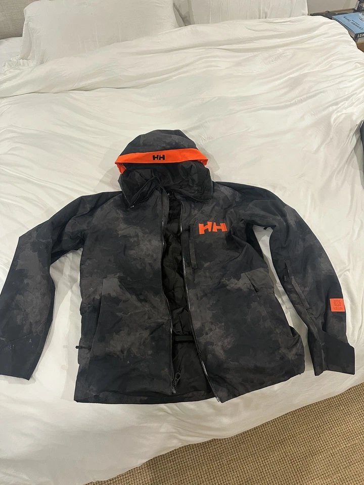 Chaqueta de esquí snowboard Helly Hansen HH mediana para hombre negra camuflada y naranja Foto 1 de 4