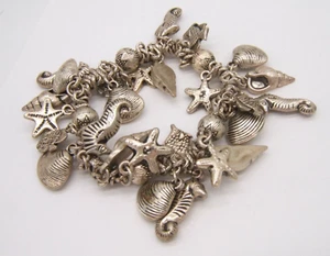 VINTAGE SILVER TONE STRETCH BRACELET SEA LIFE STARFISH SEAHORSE SHELLS LOADED - Picture 1 of 4
