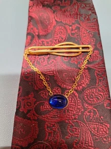 SPLENDIDO FERMACRAVATTA TONO DORATO CON ACCENTO BLU - Foto 1 di 5