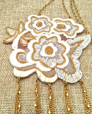 Lenora Dame Gold Tone White & Gold Embroidered Flowers 32 Inch Tassel Necklace - Image 1 of 4