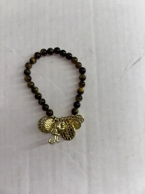 Pulsera elástica ojo de tigre Lilly Pulitzer tono dorado dijes y elefante usada en excelente estado Foto 1 de 4