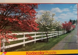 Kodacolor Puzzles Dogwood and Fence 1000 Piece Jigsaw Puzzle - Picture 1 of 3