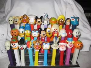 30 PEZ DISPENSERS PLUS A 3 TIER GRANDSTAND DISPLAY - Picture 1 of 3