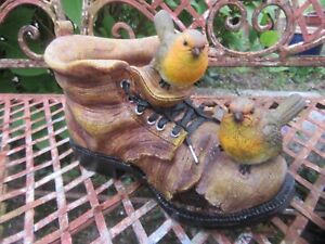 Pair of Birds Perched On a Resin Planter old Boot