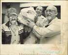 1984 Press Photo Workers giving a free whole frozen turkey to winner in Alaska
