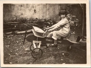 ADORABLE LITTLE GIRL RIDES HER TOY AIRPLANE  (1930) - Picture 1 of 2