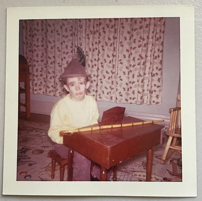 Vintage Color Photo Of Sad Faced Boy In Makeup & Costume Sitting At Toy Piano - Image 1 of 3