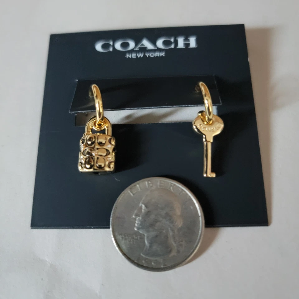 COACH GOLD TONE SIGNATURE PADLOCK & KEY HUGGIE HOOP DROP MISMATCH EARRINGS