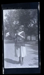 BLACK & WHITE NEGATIVE * Woman carrying a small back dog - Picture 1 of 3