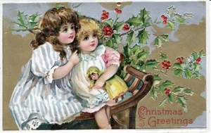 T11-80057 Antique Christmas Postcard embossed circa 1910 Girls w/ Doll in holly - Picture 1 of 2