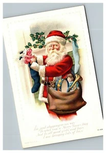 Cartolina natalizia vintage anni '10 Babbo Natale sacchetto dei regali calza ripiena - Foto 1 di 2