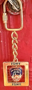 FDNY LOGO ON GOLDTONE KEY HOLDER - ROTATES - New York Firefighters - great GIFT - Picture 1 of 2